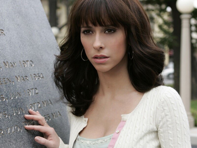 woman standing by a stone monument