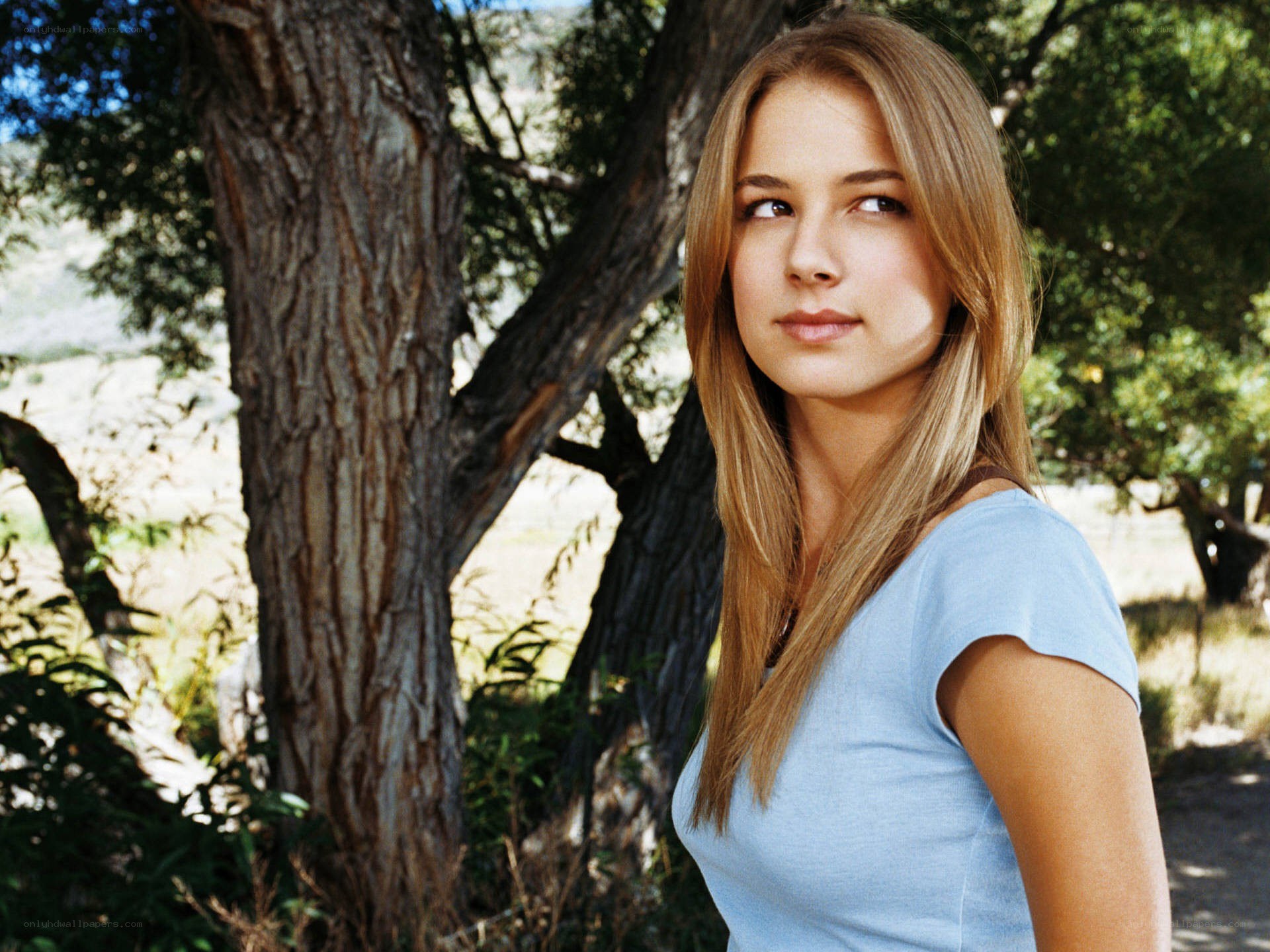 woman standing by a tree