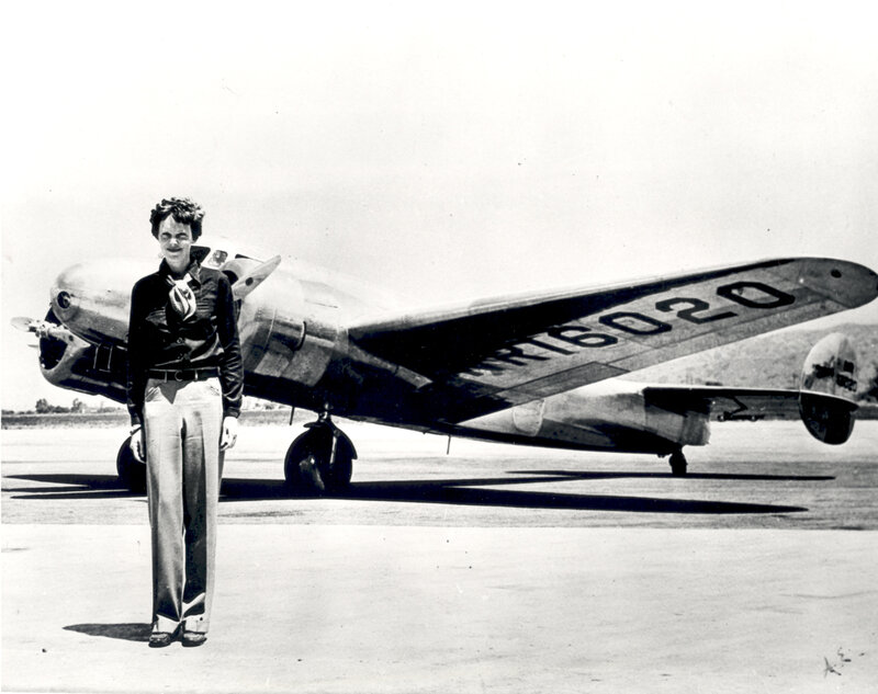 Woman standing by an airplane