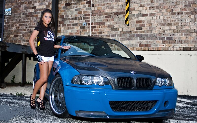 Woman Standing by Blue Car — Dramatic