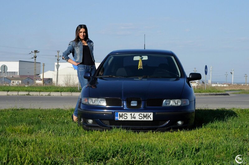 woman standing by blue car