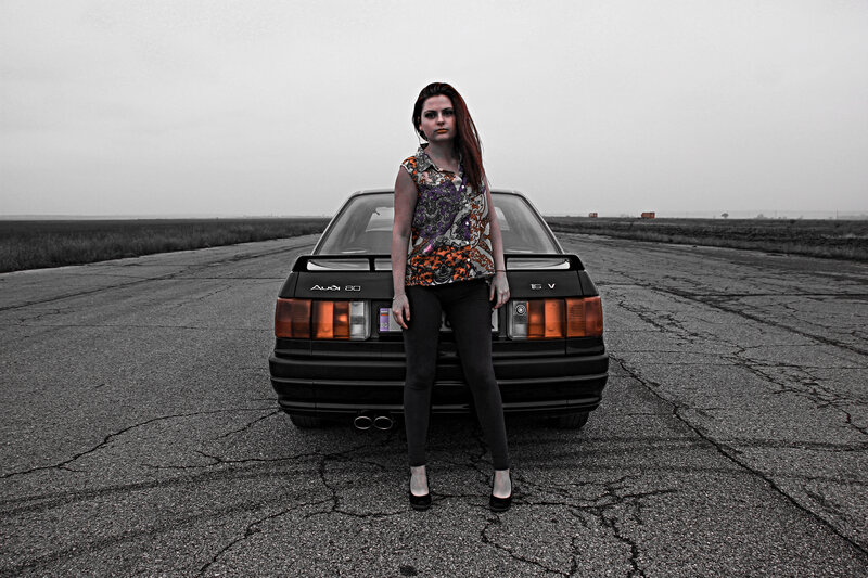 Woman Standing by Car — Black, Dramatic, Photograph