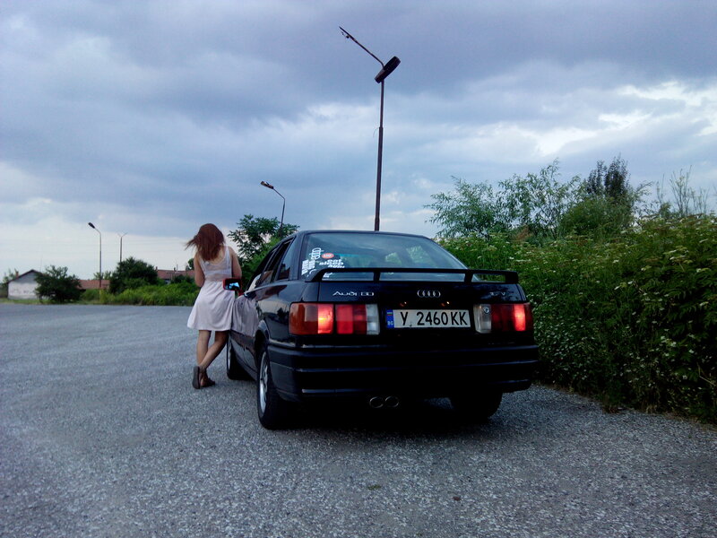 Woman Standing by Car — Gray, Overcast