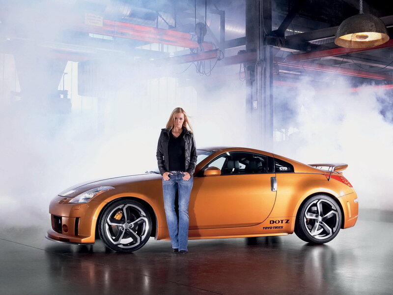 Woman Standing by Car — Orange, Dramatic