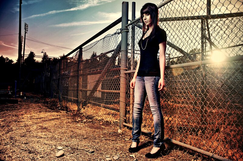 woman standing by chain-link fence