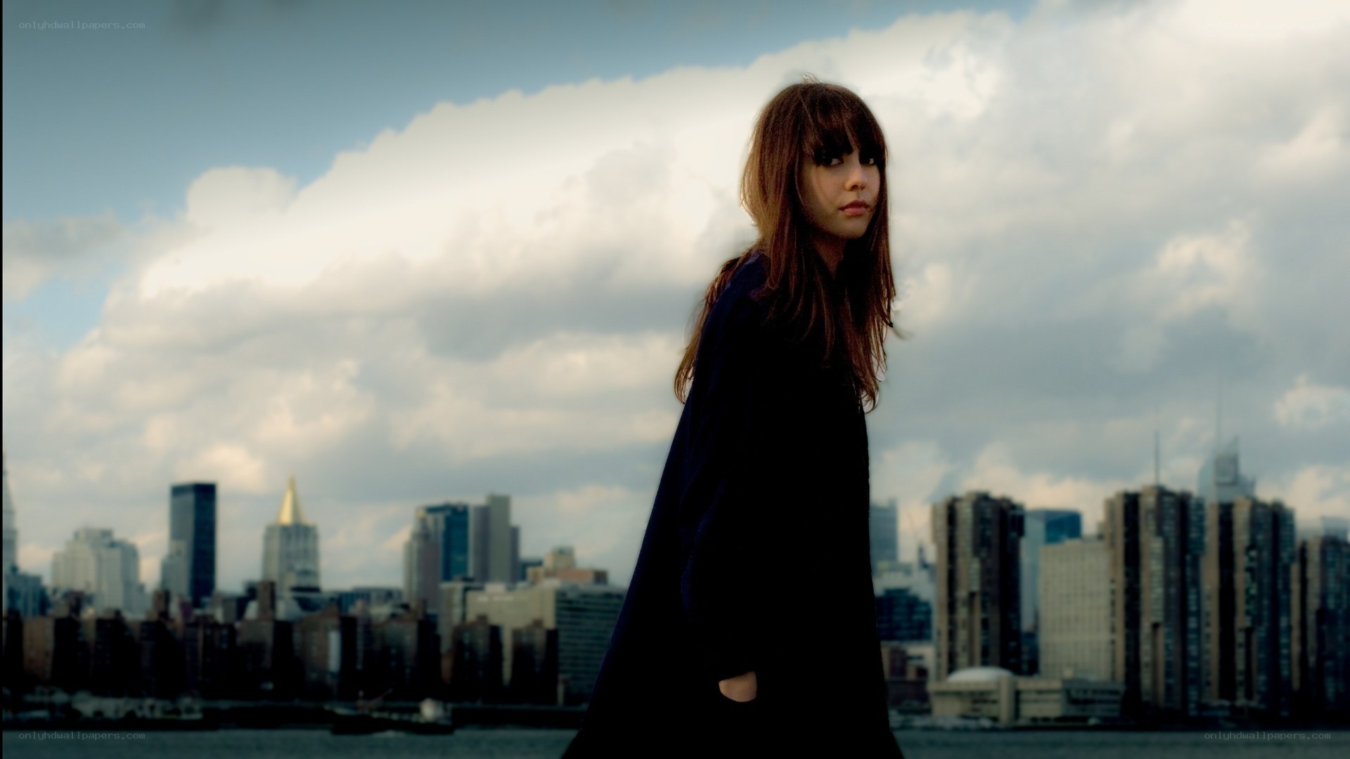 woman standing by city skyline