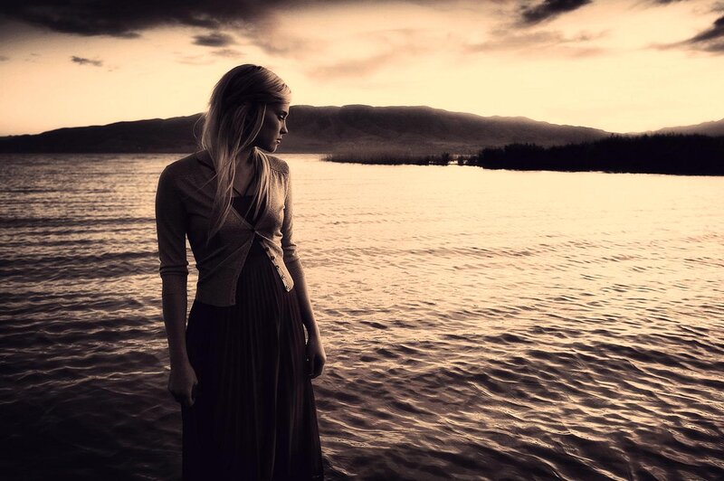 Woman Standing by Lake — Brown