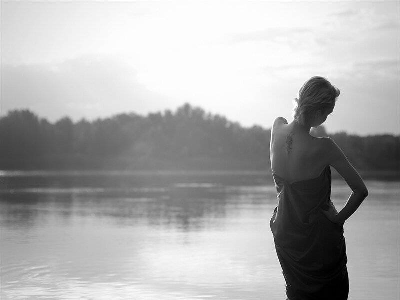 Woman Standing by Lake