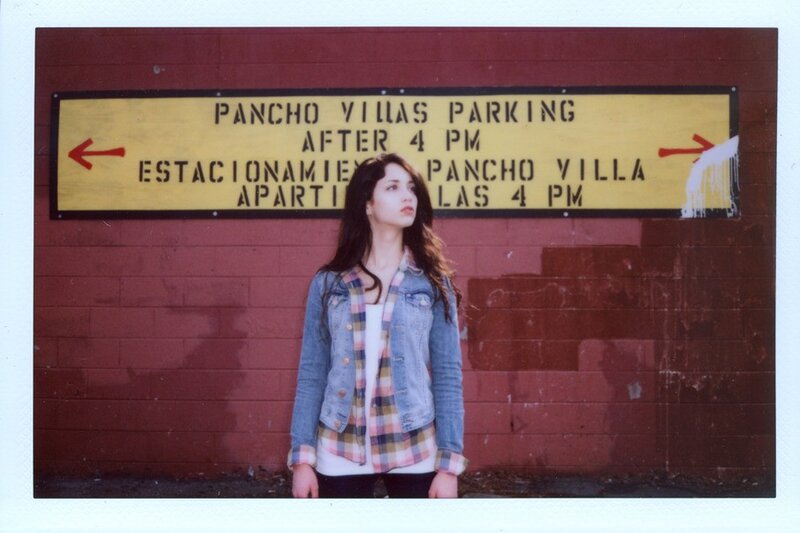 woman standing by parking sign