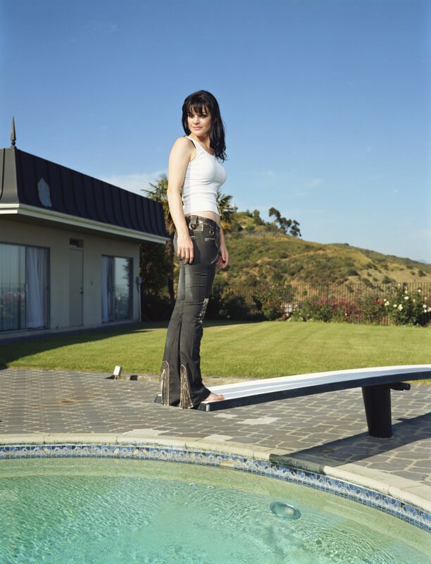 Woman standing by pool