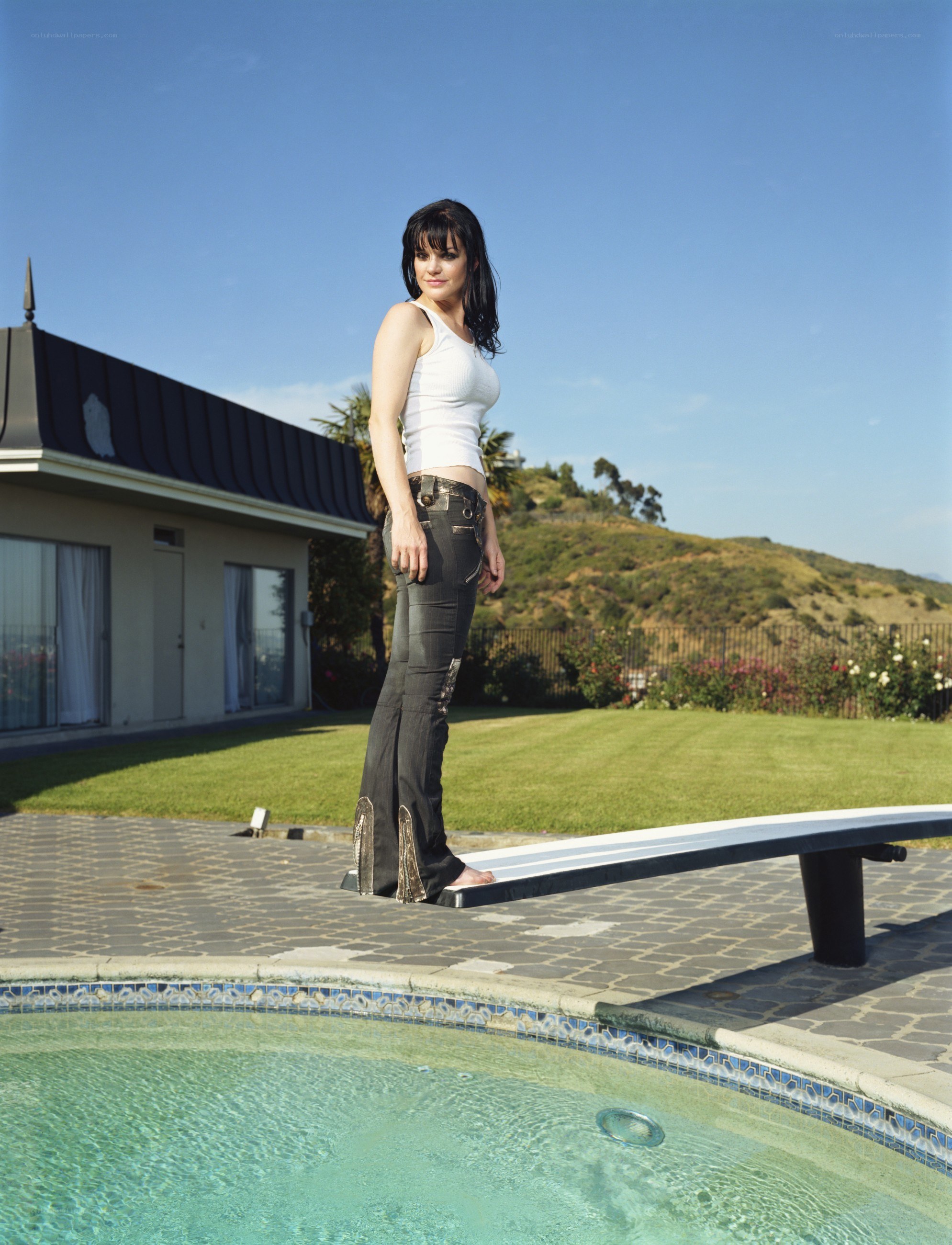 Woman standing by pool