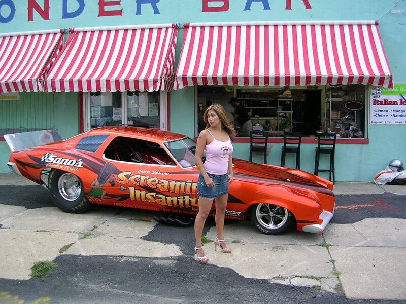 Woman Standing by Race Car — Orange