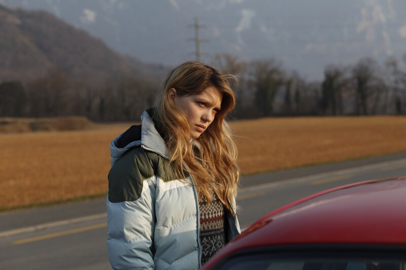 woman standing by red car
