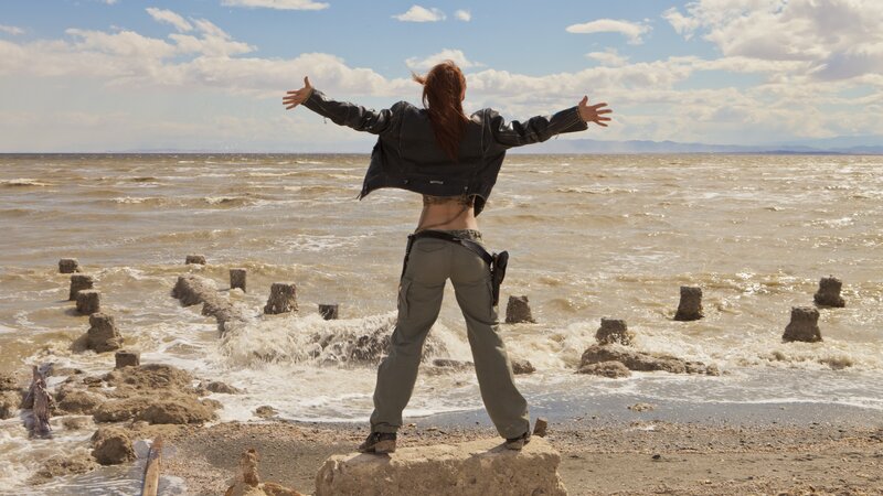 Woman standing by the sea
