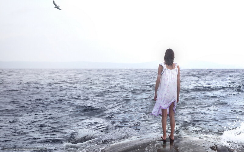 woman standing by the sea