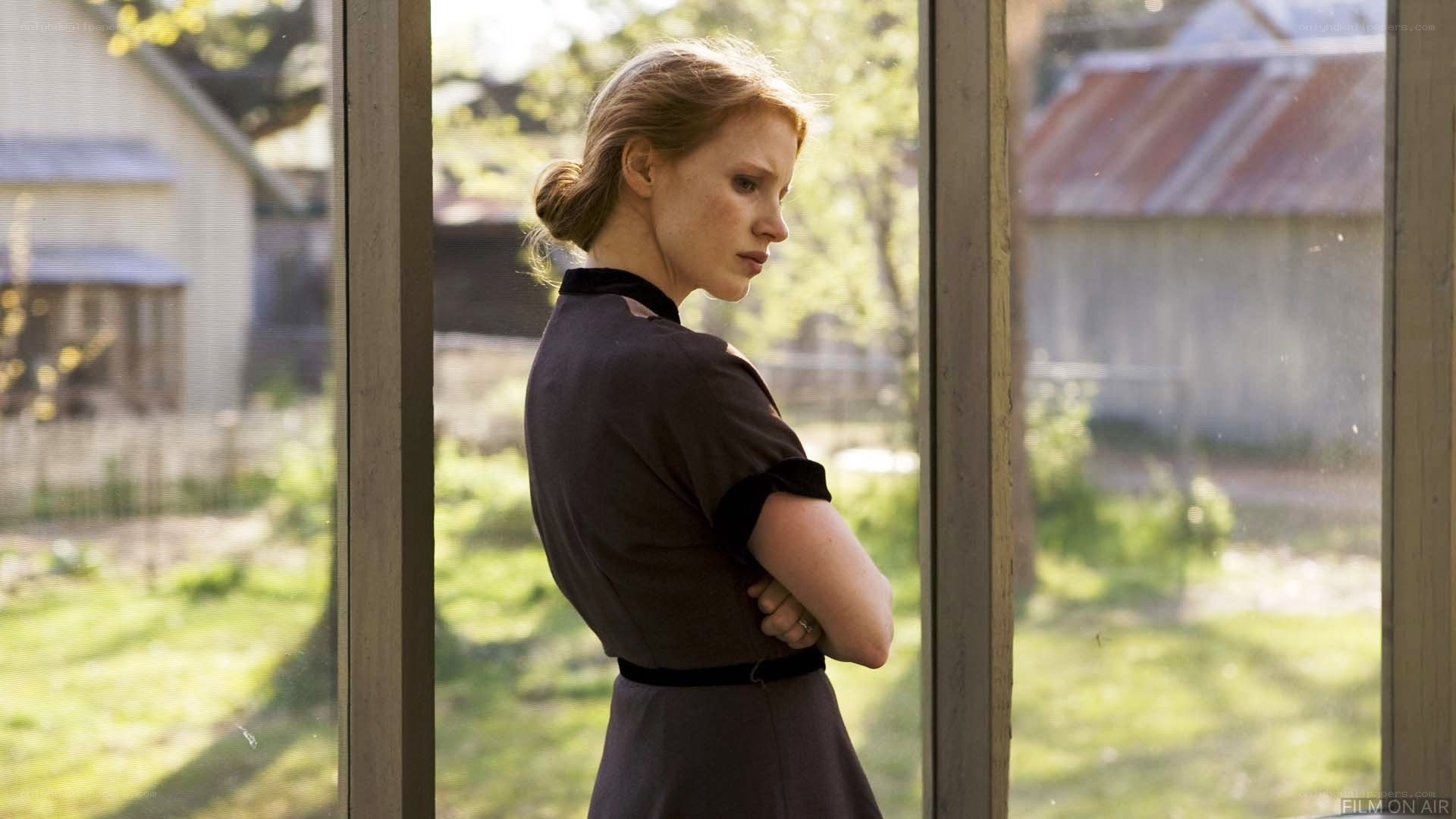 woman standing by window