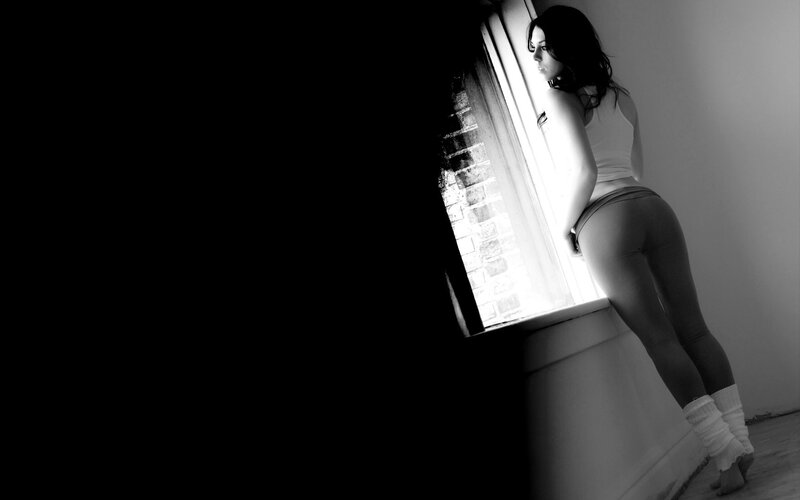 Woman Standing by Window — Black, Dramatic, Photograph, Brick Wall, Leg Warmers