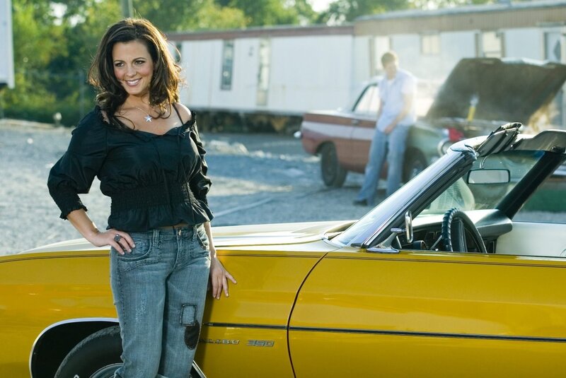woman standing by yellow car