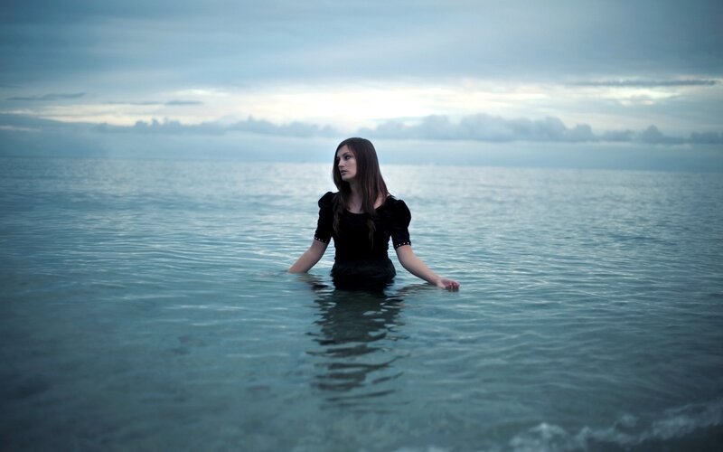 woman standing in the ocean