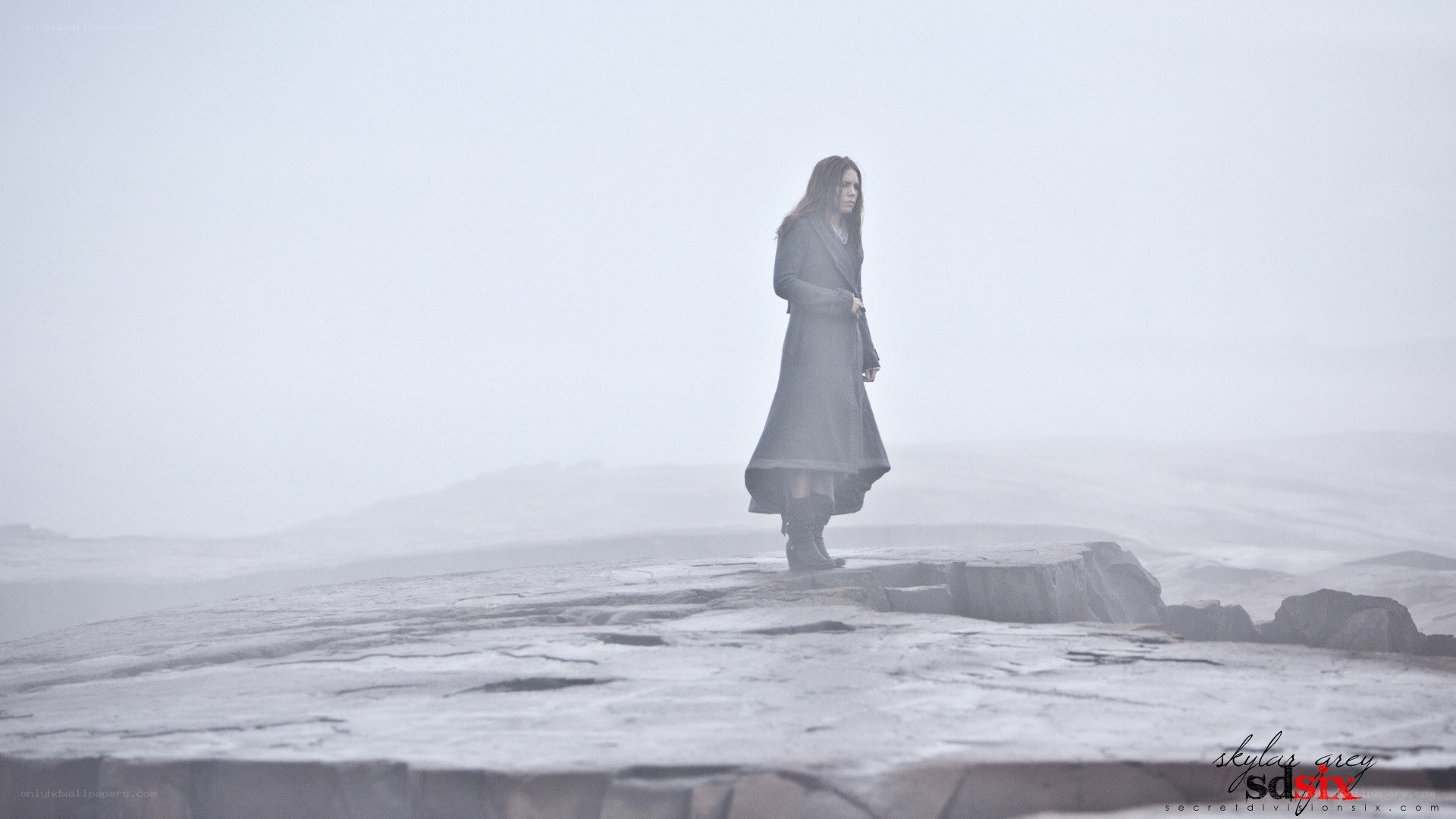 woman standing on a cliff