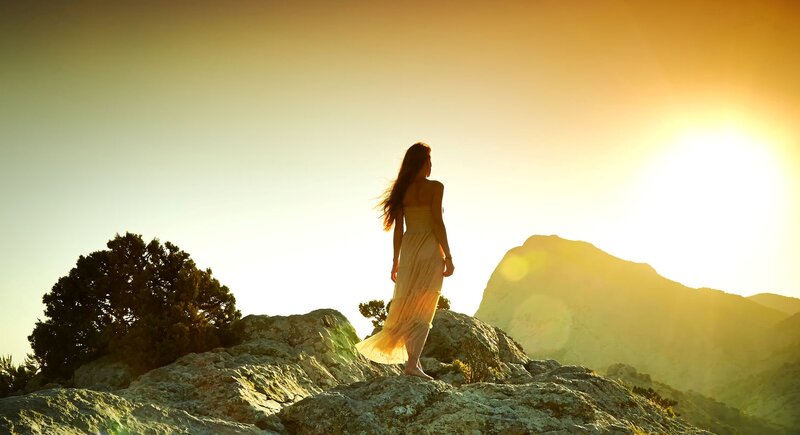 Woman Standing on a Rock