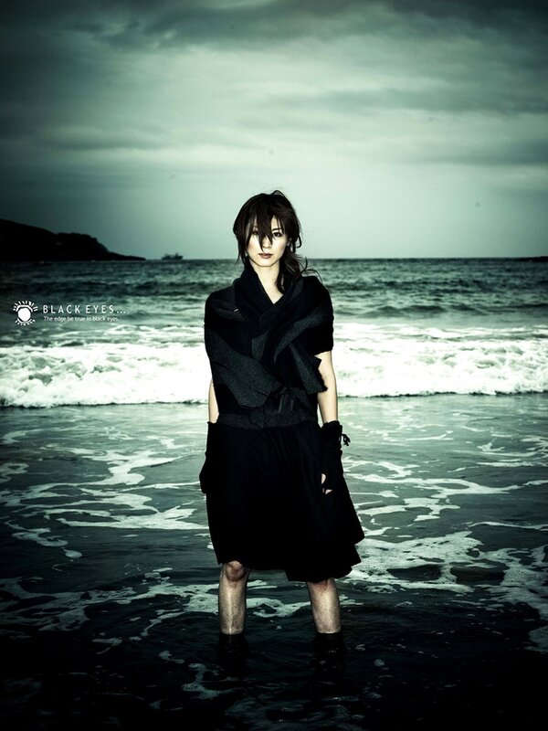 woman standing on beach at dusk