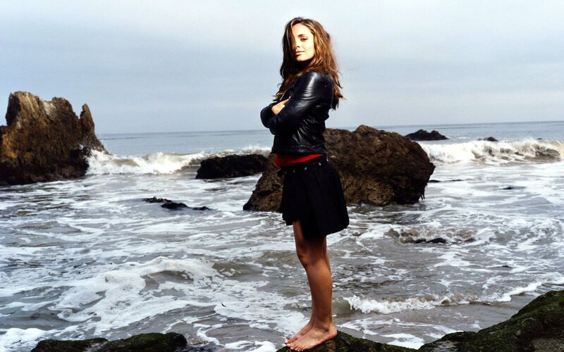 woman standing on beach rocks