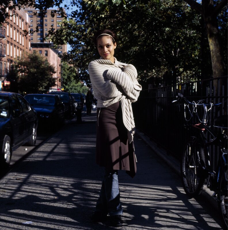 woman standing on city sidewalk