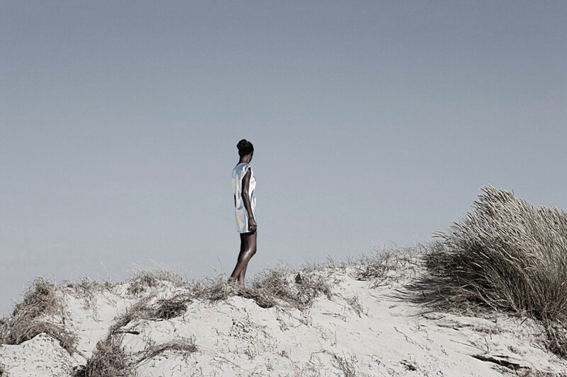 Woman Standing on Dune