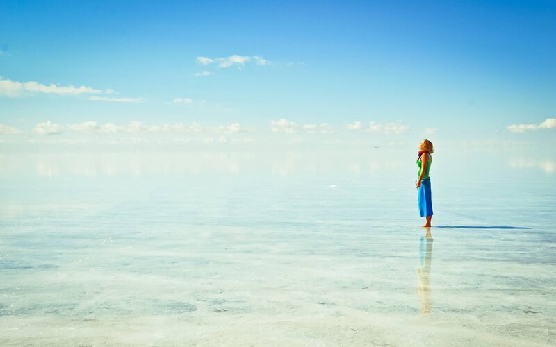Woman Standing on Salt Flat — Blue