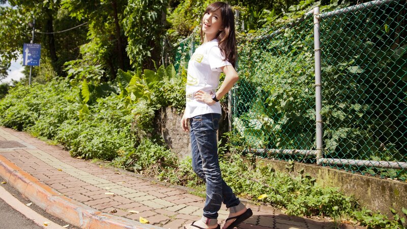 woman standing on sidewalk