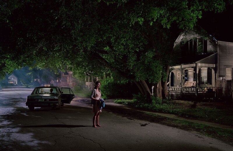Woman standing on street at night