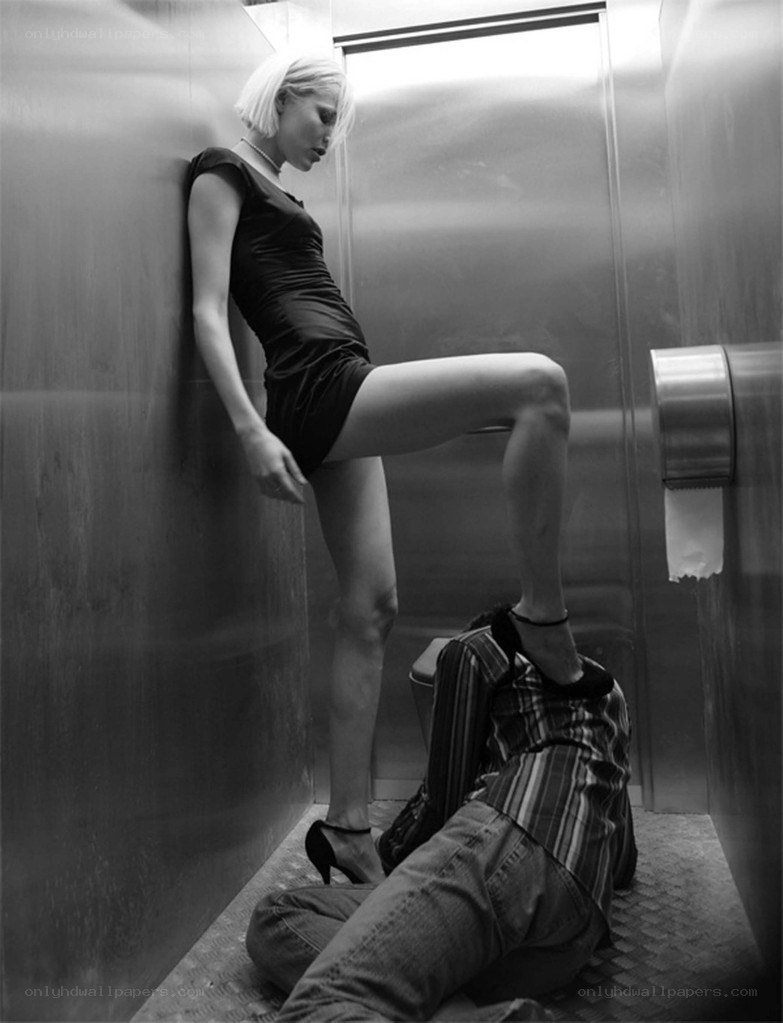 Woman standing over man in elevator