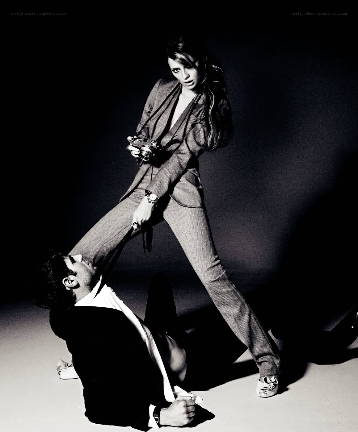 woman standing over man with camera