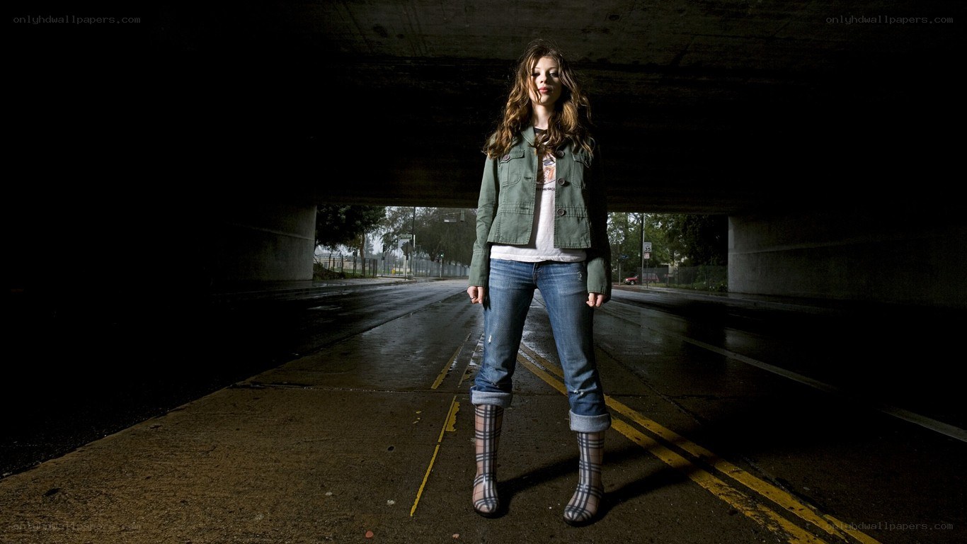 woman standing under a bridge