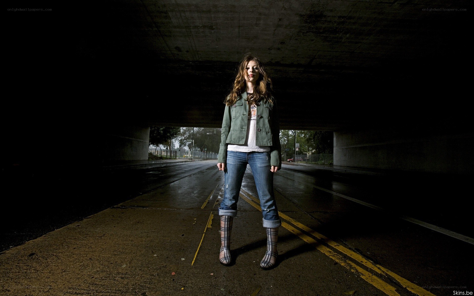 Woman standing under a bridge