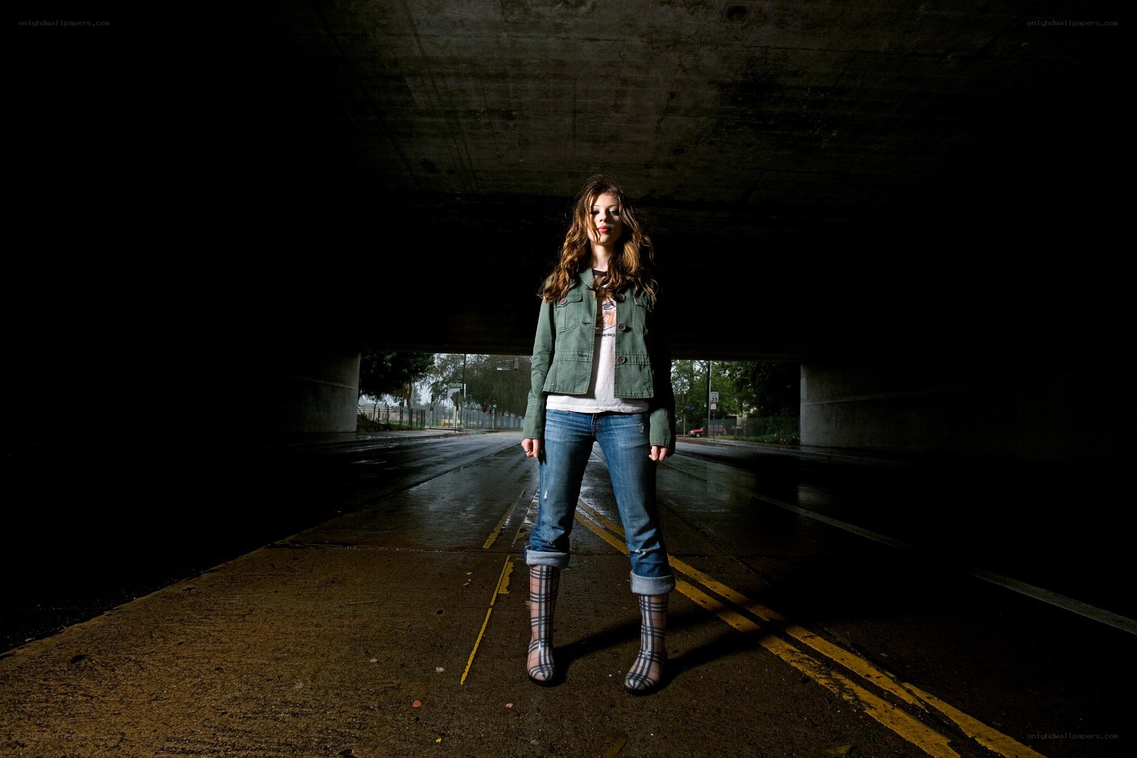 woman standing under a bridge