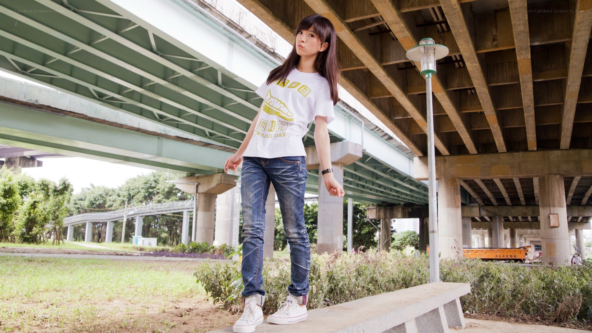 woman standing under a bridge