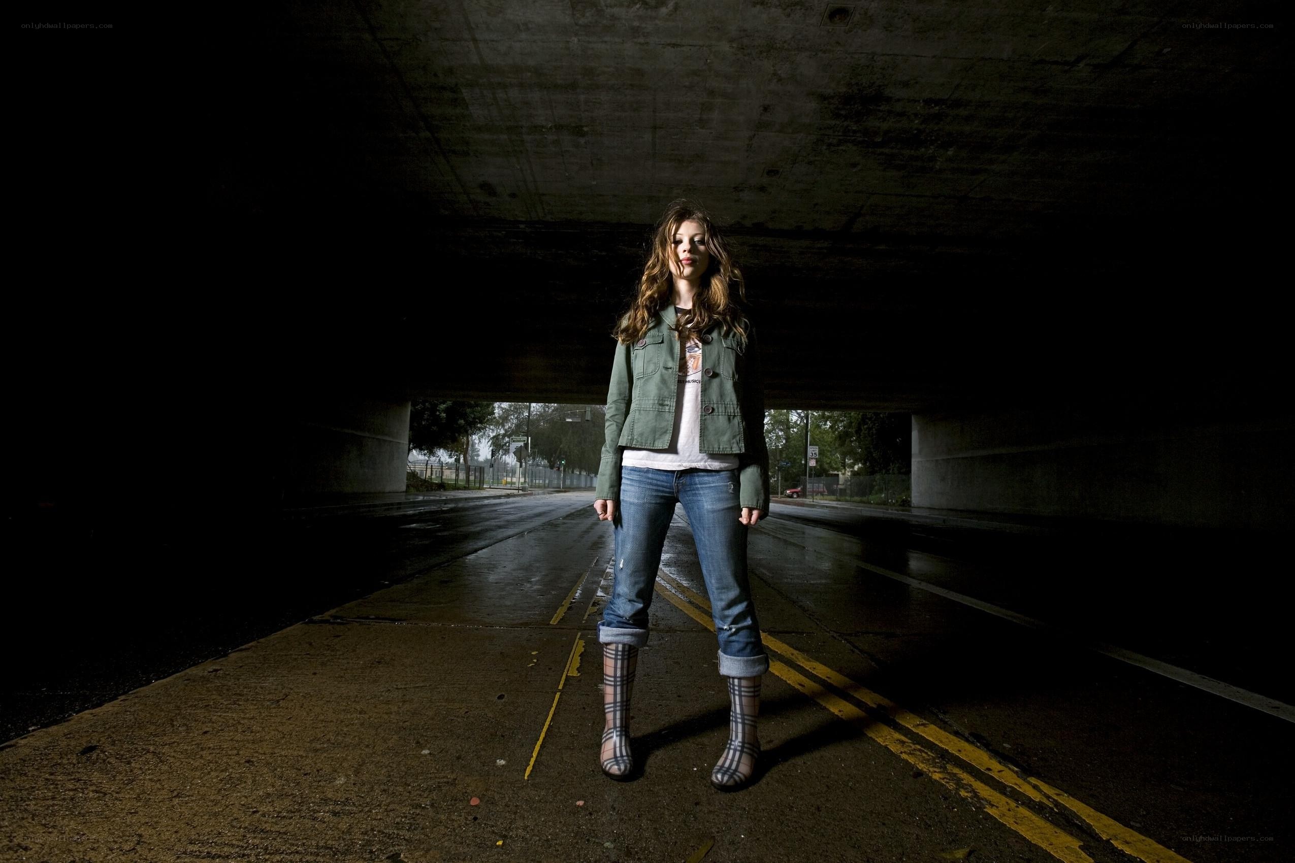 Woman standing under a bridge