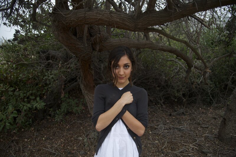 woman standing under a tree
