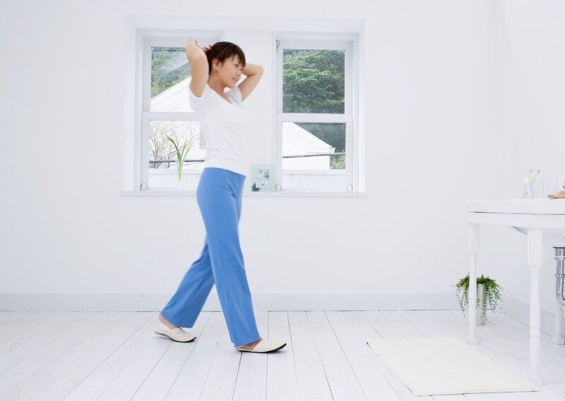 woman stretching in a bright room
