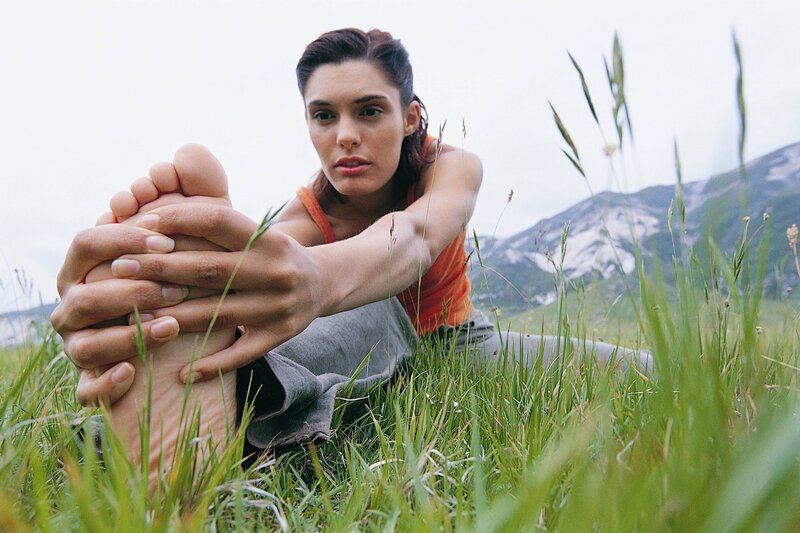 Woman stretching in a field