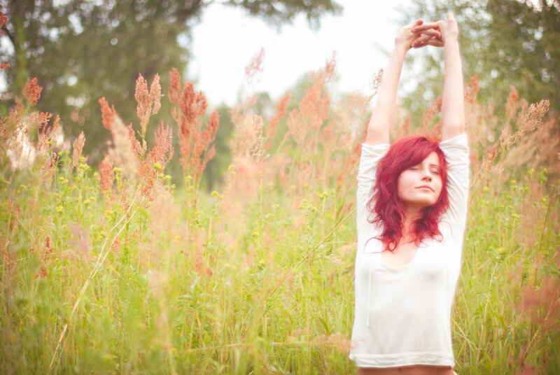 Woman stretching in a field