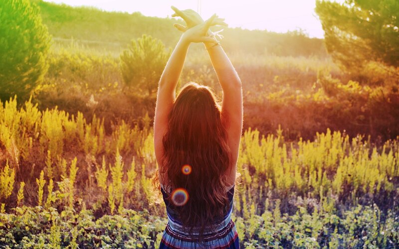 woman stretching in a field
