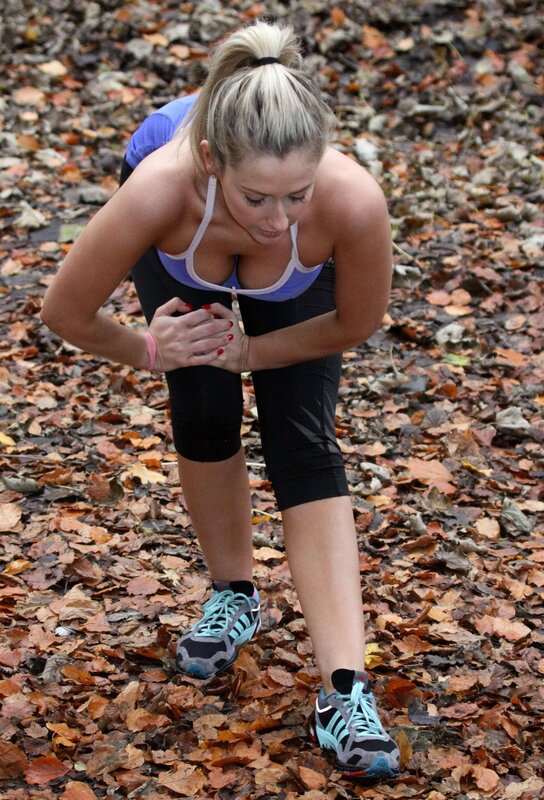 woman stretching in autumn leaves