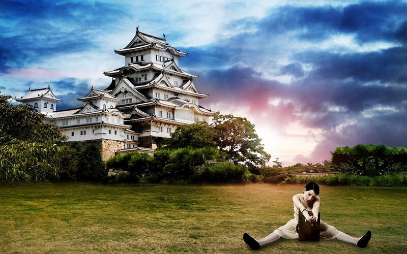 Woman stretching in front of a Japanese castle