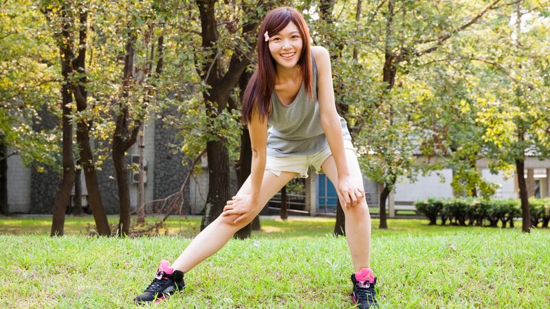 Woman stretching in park