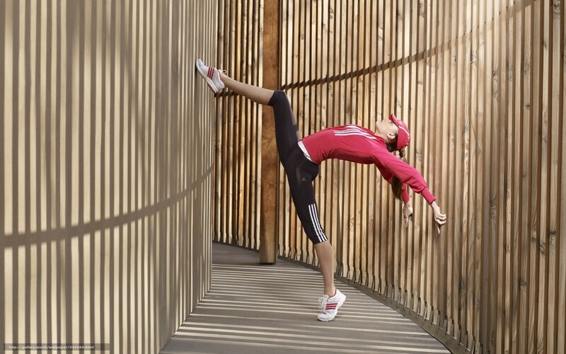 woman stretching in red outfit