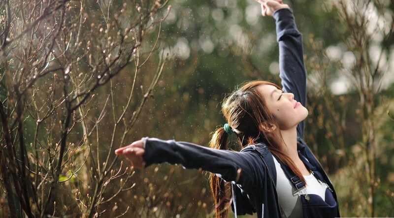 woman stretching in sunlight