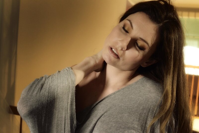 woman stretching neck at home